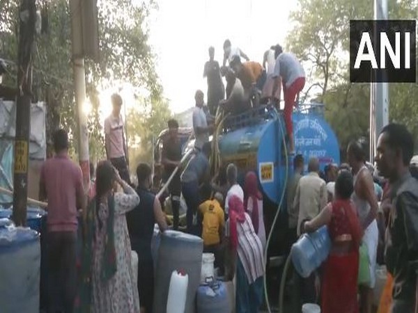 Water being supplied through tankers to Delhi locals in the Okhla area on Monday (Photo/ANI)