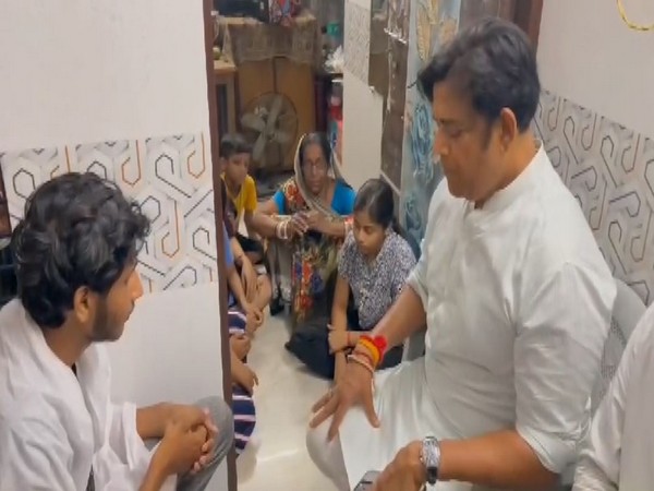 BJP MP Ravi Kishan with the family members of the deceased (Photo/ANI)