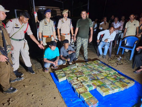 Sivasagar district police with 399 soap cases of heroin. (ANI Photo)