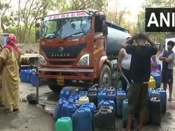 Visuals of people collecting water from tankers in Vasant Vihar area (Photo/ANI)