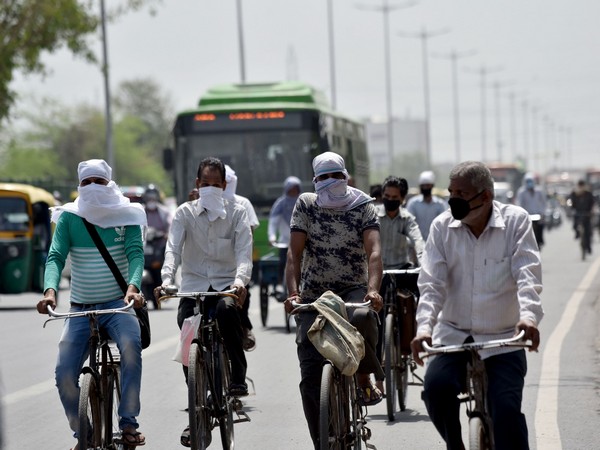 People cover their faces and heads to protect themselves from the scorching heat. (File Photo/ANI)