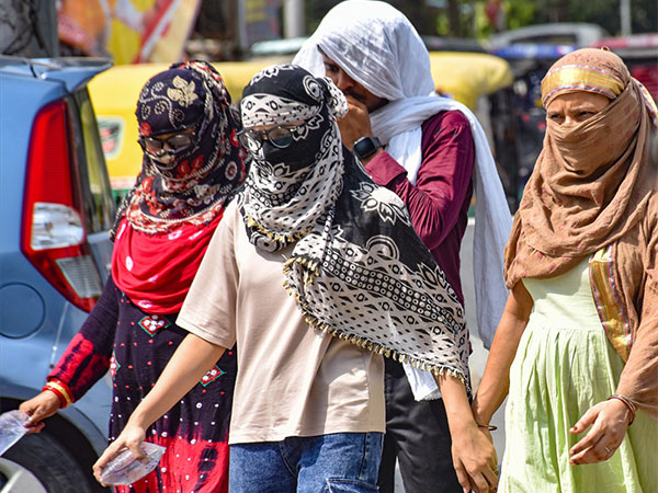 Women cover themselves with scarves to protect from the heat. (File Photo/ANI)