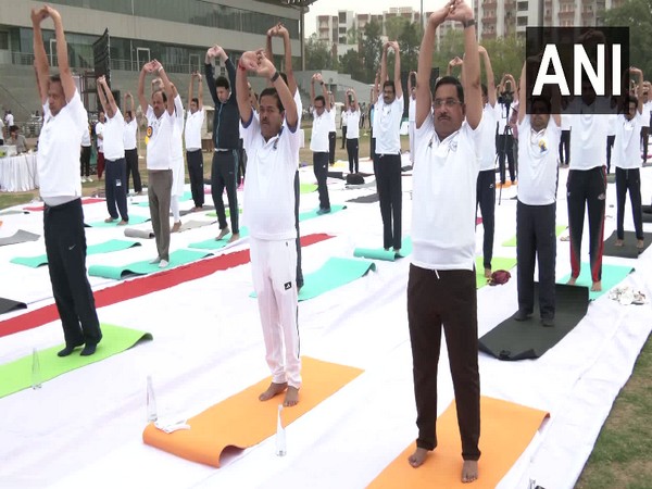 Union Ministers Pralhad Joshi and BL Verma perform yoga at an event in Delhi. (Photo/ANI)