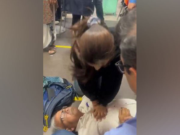 Screengrab from a viral video showing doctor saving man at Delhi Airport by performing CPR (Photo/@VasudevDevnani)