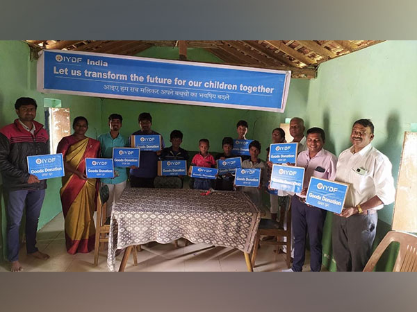 Volunteers and children display supplies from the IYDF and Coimbatore Gowtham Tools aid event
