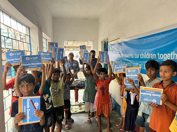 Children proudly display their supplies from the IYDF and Rahul Timber charity event in Vikash Nagar