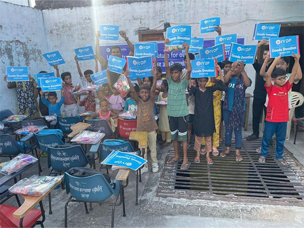  Children display their gifts and supplies from the IYDF and 8 Abs Gym event in Saket Nagar