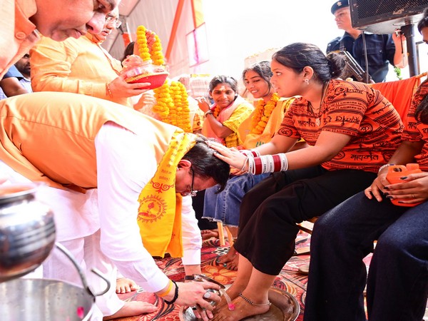 Uttarakhand Chief Minister Pushkar Singh Dhami washing the feet of Kanwariyas. (Photo/ANI)