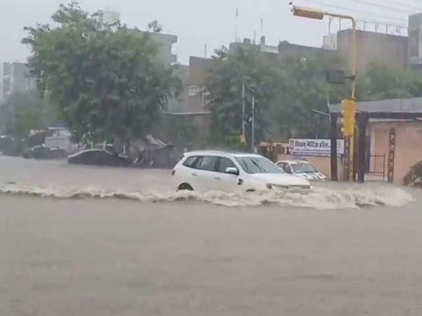 A car half submerged in rainwater in Nirman Nagar, Mansarovar (Photo/ANI)