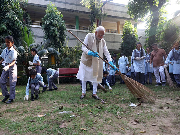 PM Modi participates in cleanliness drive at a school (Photo/ANI)