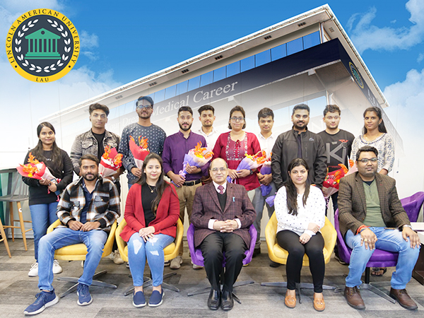 Lincoln American University staff members celebrating alongside the university's FMGE qualifiers, showcasing their success and dedication.