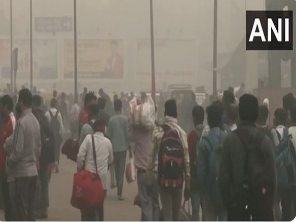 Passengers arrive at New Delhi Railway Station amid deteriorating air quality and dense smog (Photo/ANI)