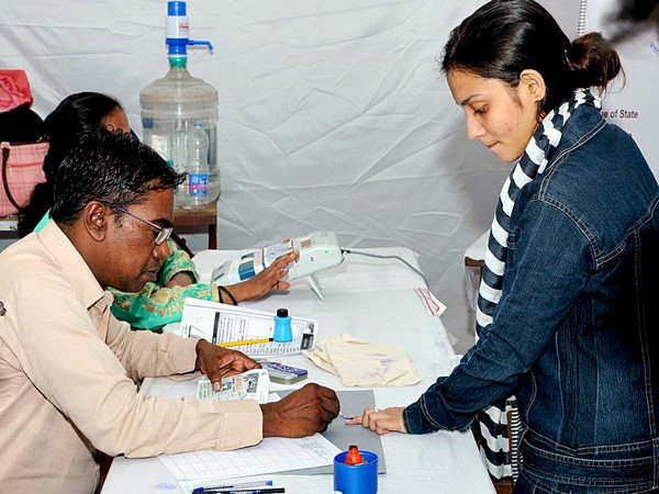 The polling official administering indelible ink to a voter in Maharashtra (Photo/ANI)