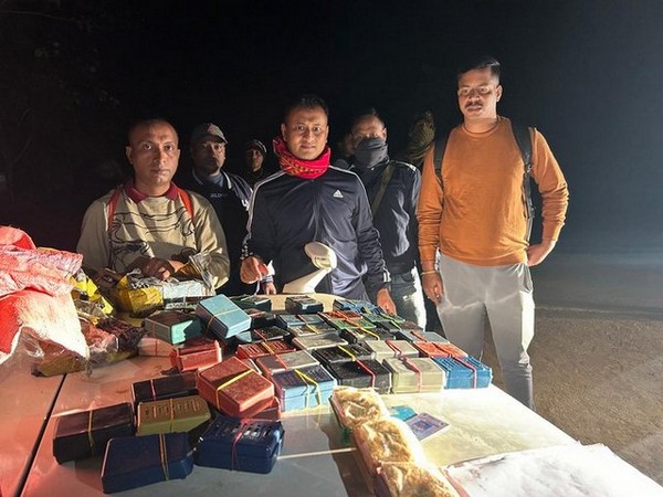 Assam police personnel with the seized contraband. (Photo/ ANI)