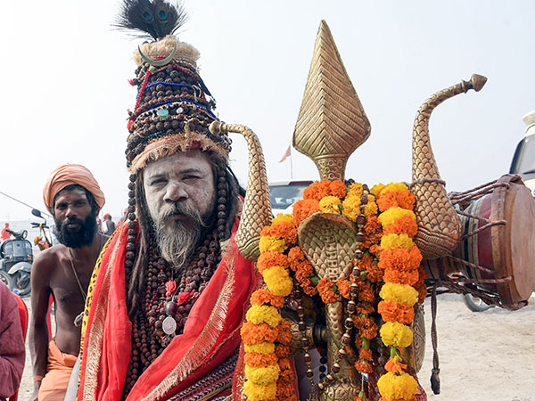 A sadhu, wearing Rudraksha and other garlands, holds a trident ahead of Maha Kumbh 2025. (Photo/ANI)