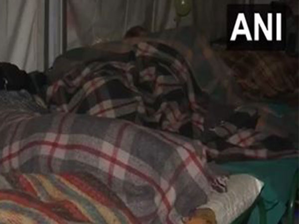 People take refuge at a night shelter as temperature dips in Delhi (Photo/ANI)