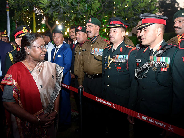 President Droupadi Murmu interacts with Army officers during an 'At-Home' reception at Army House on the eve of Vijay Diwas (ANI Photo)