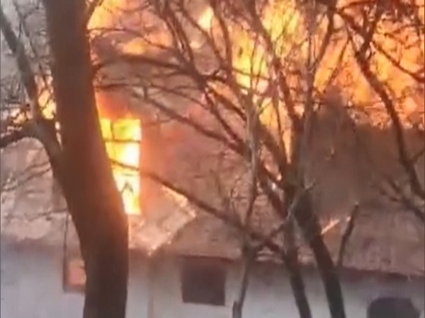 The upper story of the house engulfed in fire