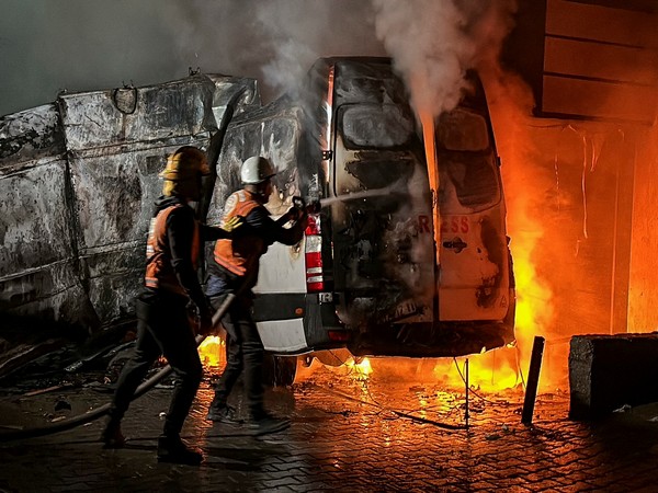 Civil Defence members trying to control fire in a broadcast van in strike that killed five journalists of Al-Quds Al-Youm television channel (Image Credit: Reuters)