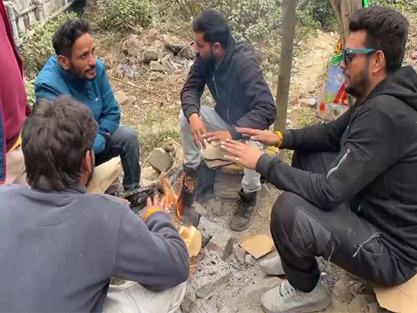 People seating near bonefire (Photo/ANI) 