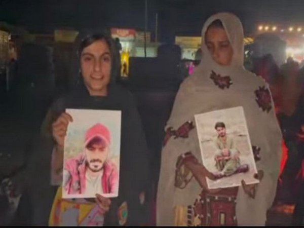 Families of missing people hold photograph of their loved ones (Image credit: @TBPEnglish)