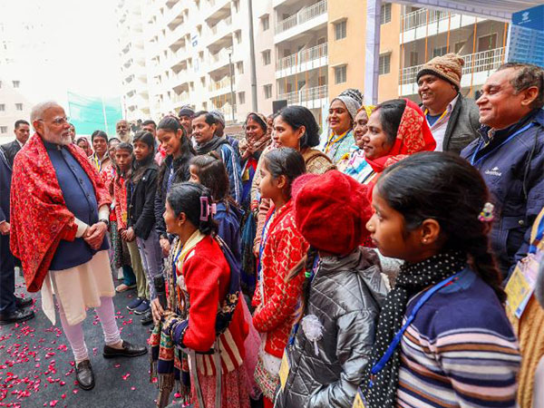 PM Modi interacts with beneficiaries of Swabhiman Apartments. (Photo/ANI)