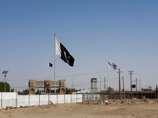 General view of the Pakistan's flag and the Taliban's flag in the background as seen from the Friendship Gate crossing point in the Pakistan-Afghanistan border town of Chaman, Pakistan (Image/Reuters)