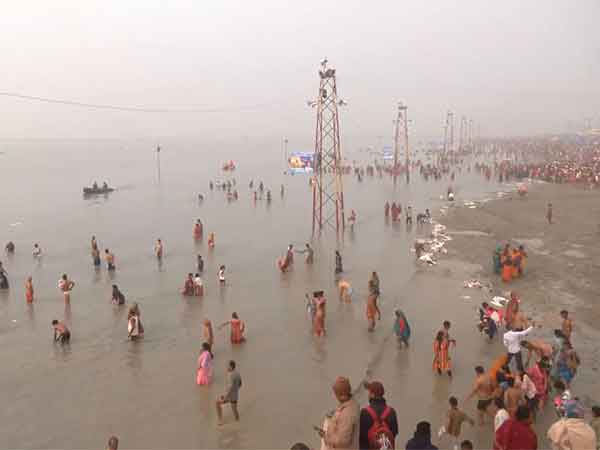 Devotees take holy dip in Ganga River in Gangasagar. (Photo/ANI)