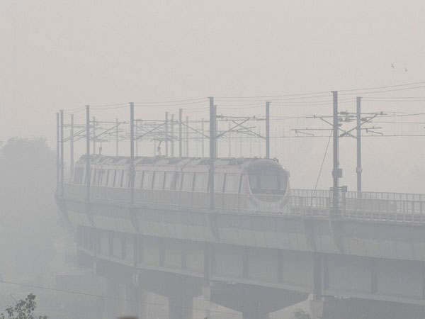 A metro train passes amid the thick layers of smog (File Photo/ANI)