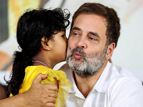 Congress leader Rahul Gandhi shares a light moment with a girl during a public meeting (File Pic/ANI)