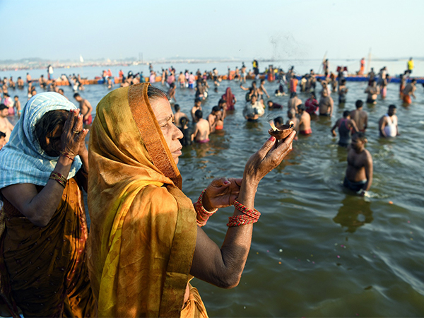 Devotees offer prayers at Triveni Sangam after taking a dip on the occasion of 'Basant Panchami' during the ongoing 'MahaKumbh' (Photo/ANI)