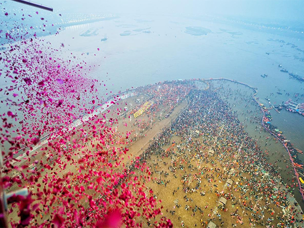 Flower petals showered on devotees taking a holy dip at Triveni Sangam
