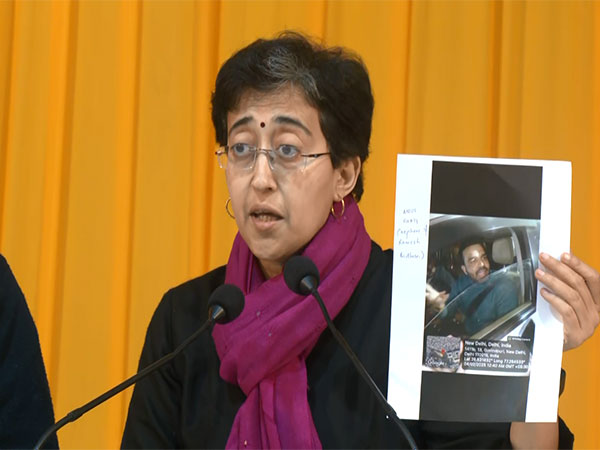 Delhi CM Atishi holds a GPS tagged photograph (Photo/ANI)