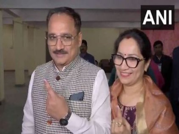 Delhi BJP President Virendraa Sachdeva and his wife show their inked fingers after casting their votes (Photo/ANI)