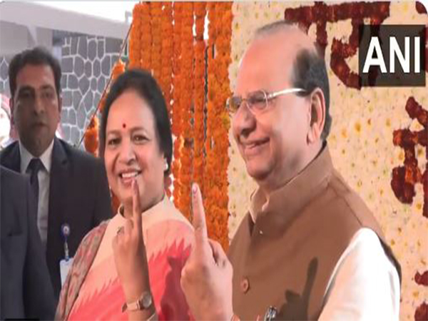 Delhi LG VK Saxena, his wife Sangita Saxena show their inked fingers after casting their vote (Photo/ANI)