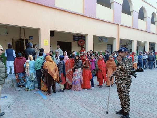 Voters stand in queue at a booth in North-East Delhi (Photo/@ECISVEEP)