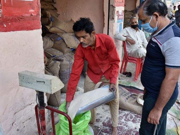 People take rice from a Government Ration Shop (File Photo/ANI)
