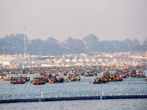 Devotees arrive in boats to take a dip at Triveni Sangam during the ongoing Mahakumbh