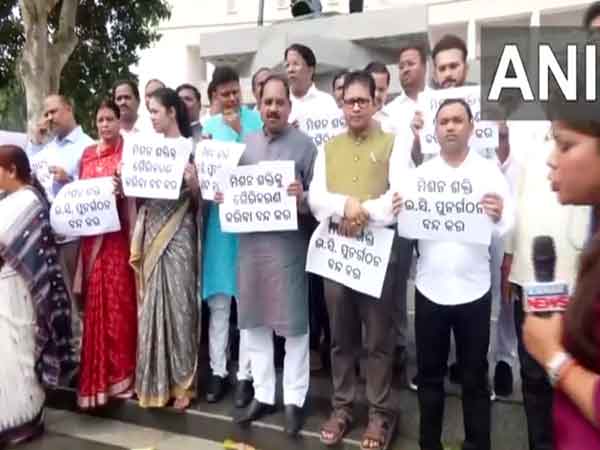 Protesting BJP MLAs under the statues of Mahatma Gandhi (Photo/ANI)