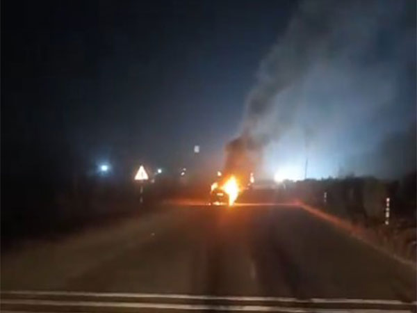 Car catches fire on national highway in Telangana's Suryapet district (Photo/ANI)