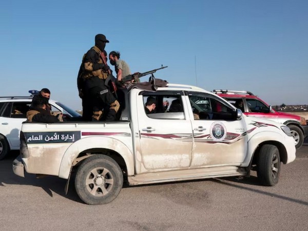 Syrian army personnel travel in a military vehicle as they head towards Latakia to join the fight against the fighters linked to Syria's ousted leader Bashar al-Assad in Aleppo (Image/Reuters)