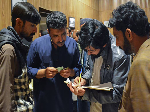 Passengers who were rescued from a train after it was attacked by separatist militants, get themselves registered at the Railway Station in Quetta, Balochistan (Image/Reuters)