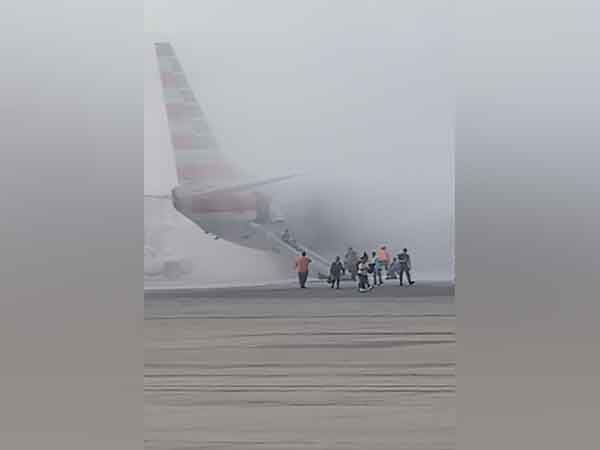Passenger evacuate American Airlines plane after an engine fire (Photo/ Credit: Aaron Clark/via REUTERS)