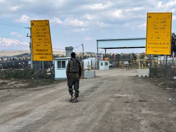 An Israeli soldier walks by the fence of the ceasefire line by Syria and the Israeli-occupied Golan Heights, at Quneitra crossing in the Golan Heights (Image/Reuters)