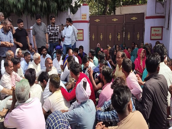 People staging sit-in outside Collector's Bunglow (Photo / ANI)