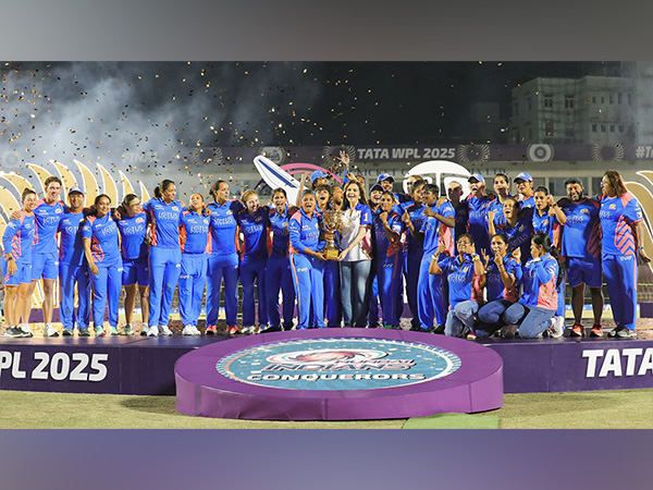 Nita Ambani with Mumbai Indians team holding the WPL trophy (Photo: Reliance Foundation)