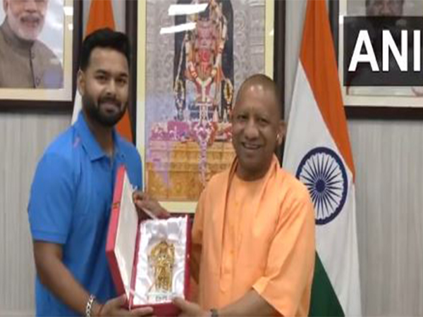 Rishabh Pant (L) and Uttar Pradesh Chief Minister Yogi Adityanath