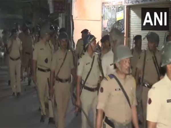 Maharashtra Police and security personnel conduct a flag march in the violence-hit area to instil confidence among people (Photo/ANI)