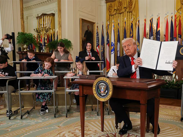 US President Donald Trump shows his signature on an executive order to shut down the Department of Education, during an event in the East Room at the White House in Washington DC (Image/Reuters)