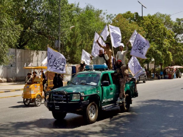Members of the Taliban carrying flags participate in a rally to mark the third anniversary of the fall of Kabul, in Kabul, Afghanistan (File Image/Reuters)